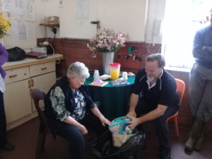 Jackie and her son, Mark, look at presents from the residents.
